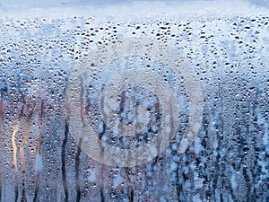 Window glass close-up, showing severe water droplet condensation.