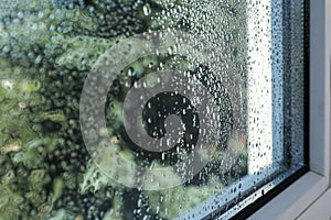 Window glass with drops of condensate, closeup