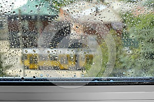 Window glass with drops of condensate indoors, closeup