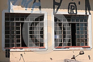 Window glass, iron square. Antique construction, graffiti on the wall. Urban characteristic