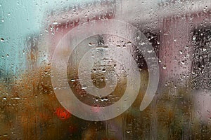 Window glass with raindrops and blurs