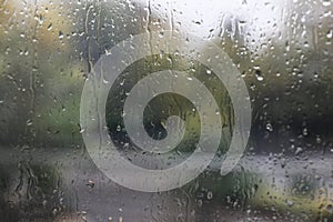 Window glass with water drops, closeup. Rainy weather