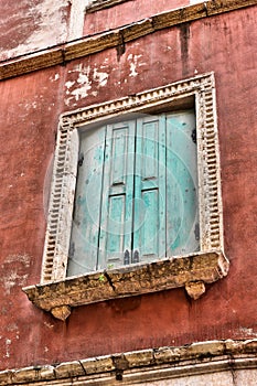 Window with green shutters on an old historic building in Verona