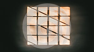 A window with a grid pattern and sunlight shining through.