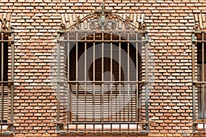 Window with grill on a brick wall