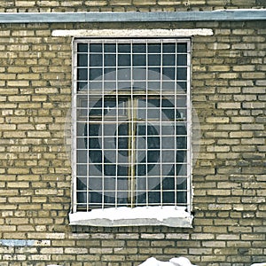 Window grille on a window of old soviet brick house