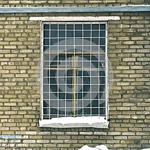 Window grille on a window of old soviet brick house