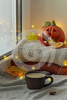 Window with Halloween decoration. Pumpkin with candle