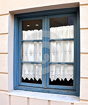 Window with hand made embroidered curtain in Vathi town, Ithaca island, Ionian islands, Greece.