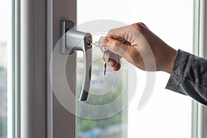 Key locking window with key for kids safety. Window Restrictors in the home. photo