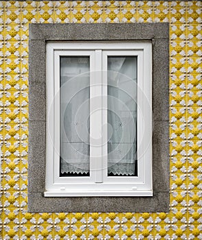 Window, home with yellow tile facade in the fishermen`s neighborhood in Aveiro, Portugal