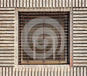 Window with horizontal bars on a brick wall