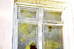 The window in the house is broken glass hooliganism