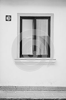 Window of a house with pilgrim sign.
