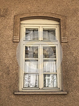 Window of a house with vintage curtains