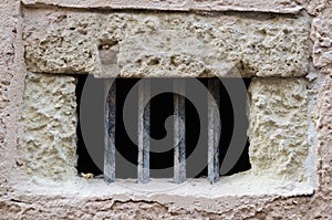 Window with iron bars on old facade