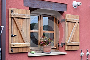 Window with its shutter looking at the sun