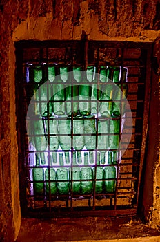 Window of green wine bottles in a wine cellar