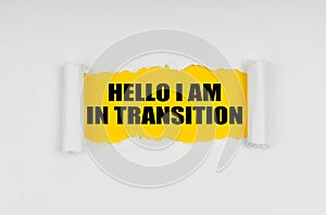 A window is made in the paper, where on a yellow background the inscription - Hello I Am In Transition