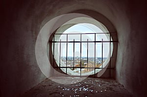 Window in the old bell tower with the lattice overlooking