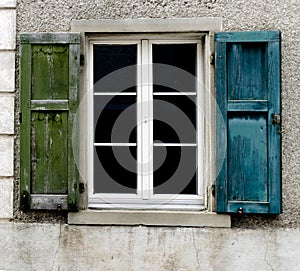 Window with old blue and green shutters