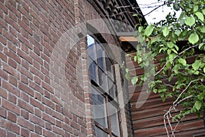 Window of an old brick house in the garden