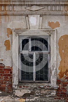 Window in an old house, brick walls with crumbling plaster