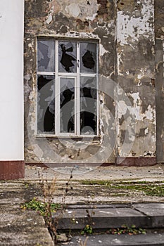A window in an old house. Broken glass.