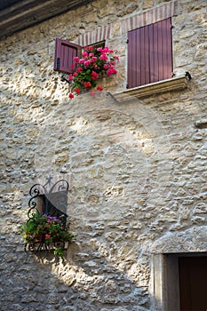 Window in an old house decorated with flower