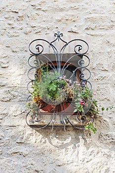 Window in an old house decorated with flower pots