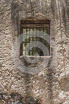 Window of an old house in a wall of adobes and quarry