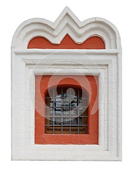 The window of the old medieval church is framed by a white plaster clype.