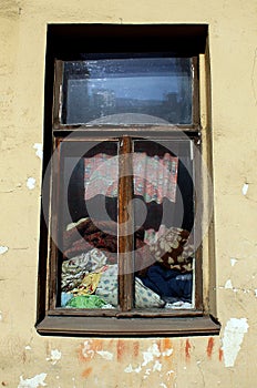 The window of old scary house at Dostoevsky street with a lot of old textile seen inside.