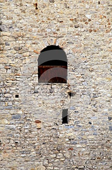 Window in old stone wall of medieval castle