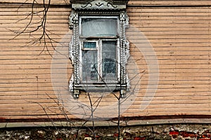 Window of an old village house with carved platbands in the Russian countryside. Selective focus