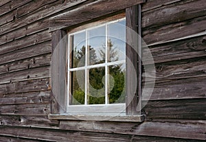 Window of old wooden cottage in the countryside. Old hut and window in a rural. Rustic house