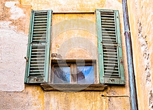 Window with old wooden shutter.