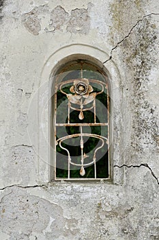 Window opening with forged lattice in a wall to a property in Malcesine in Italy