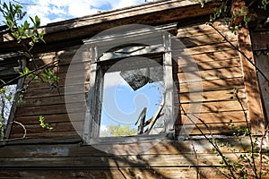 Window opening of an old ruined wooden house. Russia