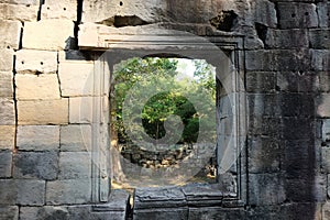 Window opening in an old stone wall. Empty window