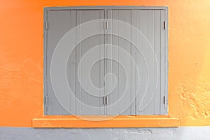 Window on orange cement wall