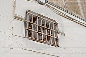 Window of prison cell with bars, close up