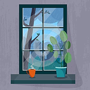 Window with a rainy city view. House plant and cup of tea or coffee on the windowsill.