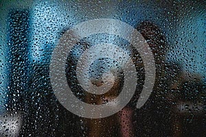 Window in a rainy day, water drops on defocused background