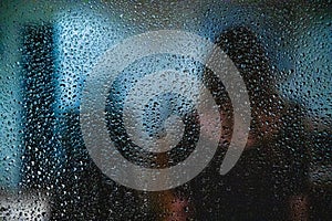 Window in a rainy day, water drops on defocused background