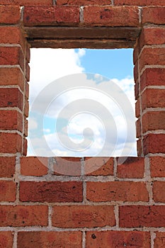 Window in red brick wall view to sky