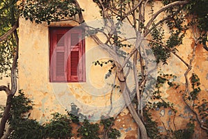 Window with red shutter of Anafiotika in town of Athens,Greece.