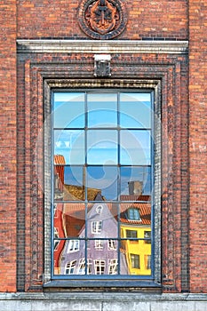 The window reflection of Nyhavn townhouses in Copenhagen.