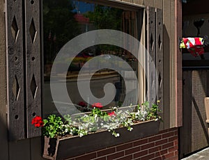 Window reflections above a traditional flower box