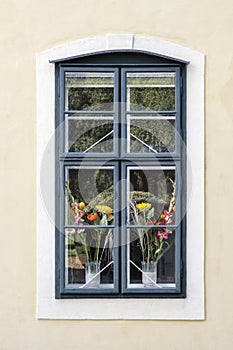 Window of a romantic and colorful house with flower pots